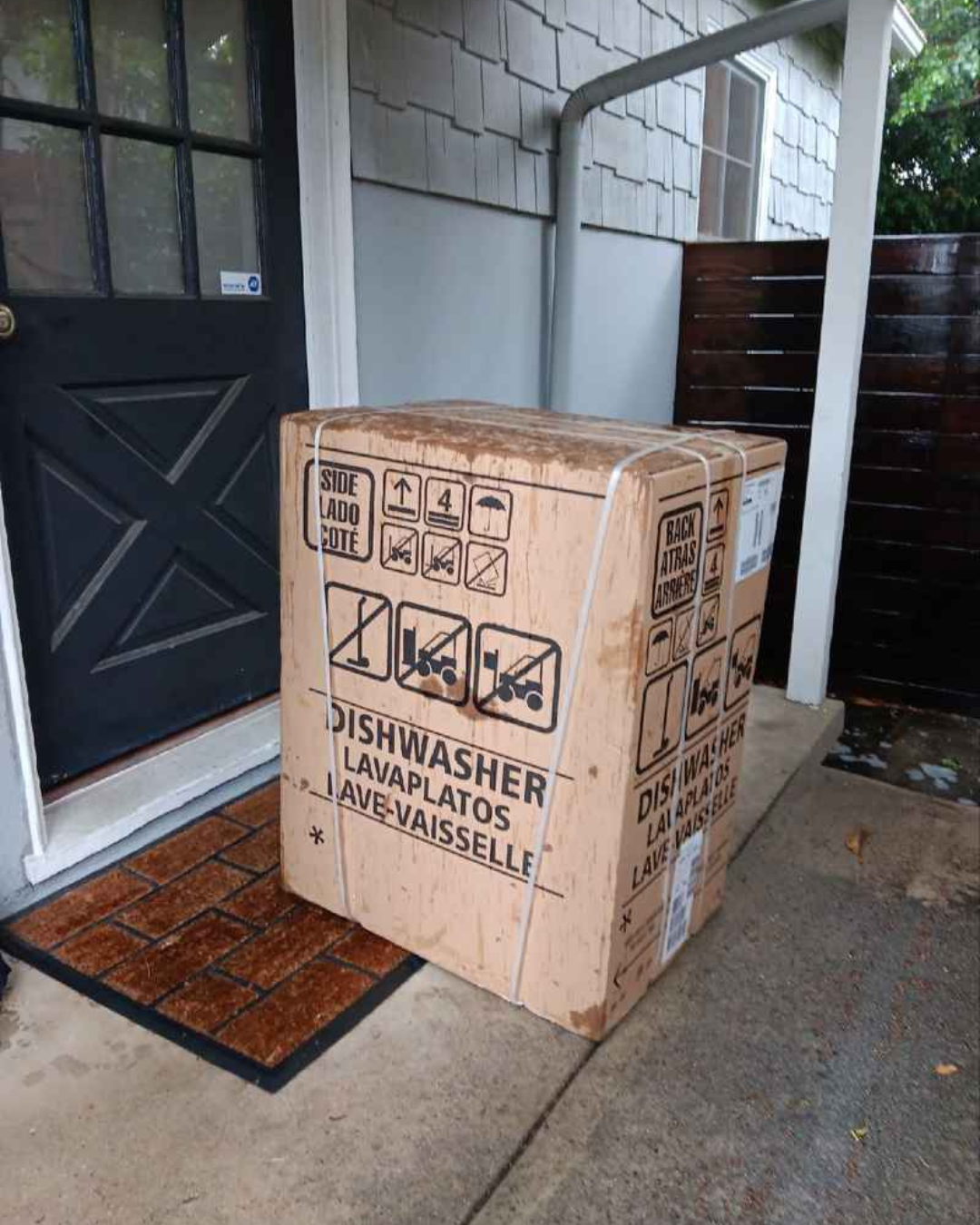 Lugg team unloading a replacement appliance onto a front porch after a hurricane.