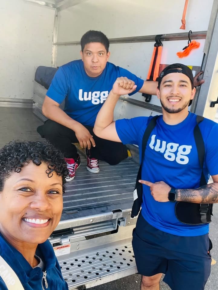 Two Lugg movers inside a box truck ready to accept moving jobs