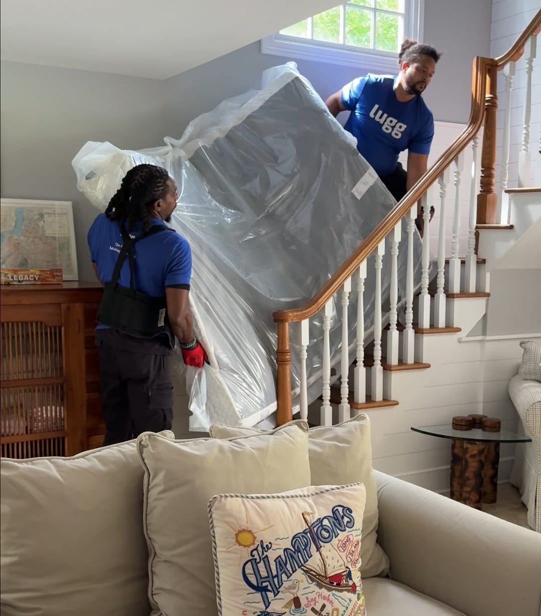 Lugg movers carry a queen mattress downstairs for a mattress return