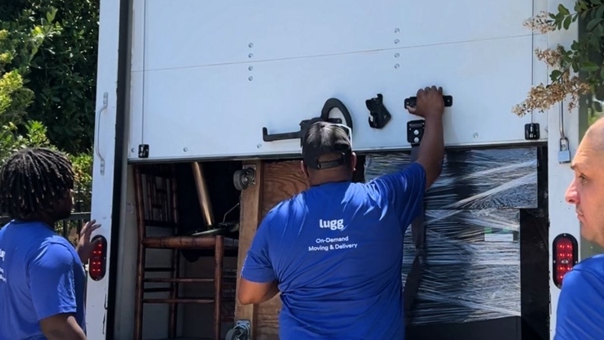 Lugg movers loading furniture into a box truck for on-demand moving and delivery work.
